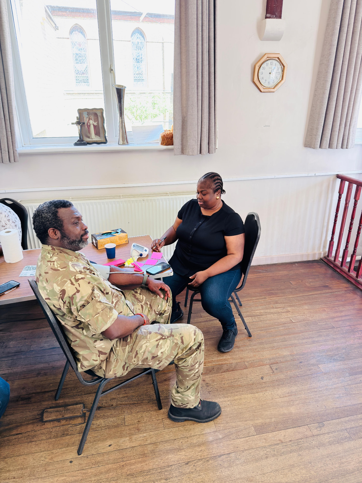 Volunteer performing a blood pressure check on a community member