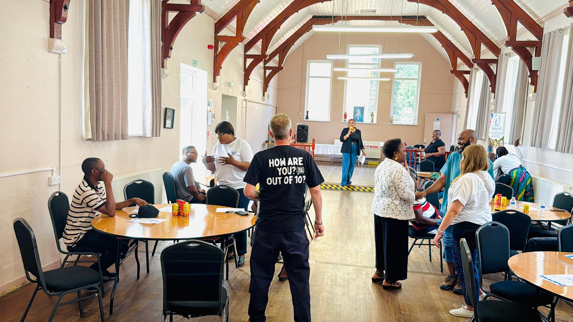 Community hall with tables and people during a wellbeing event